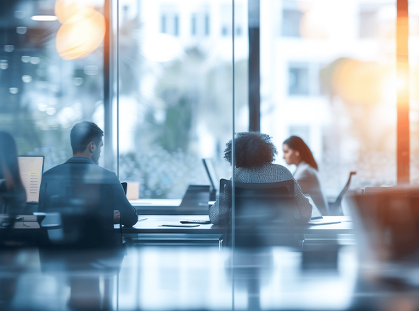 Modern-Office-Workspace-with-IT-Professionals-and-Programmers-Collaborating-Behind-Glass-Wall