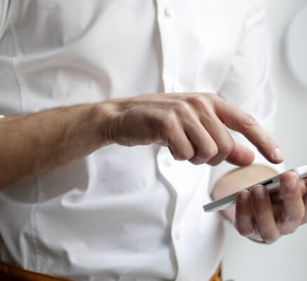 A man using his phone to make a call 